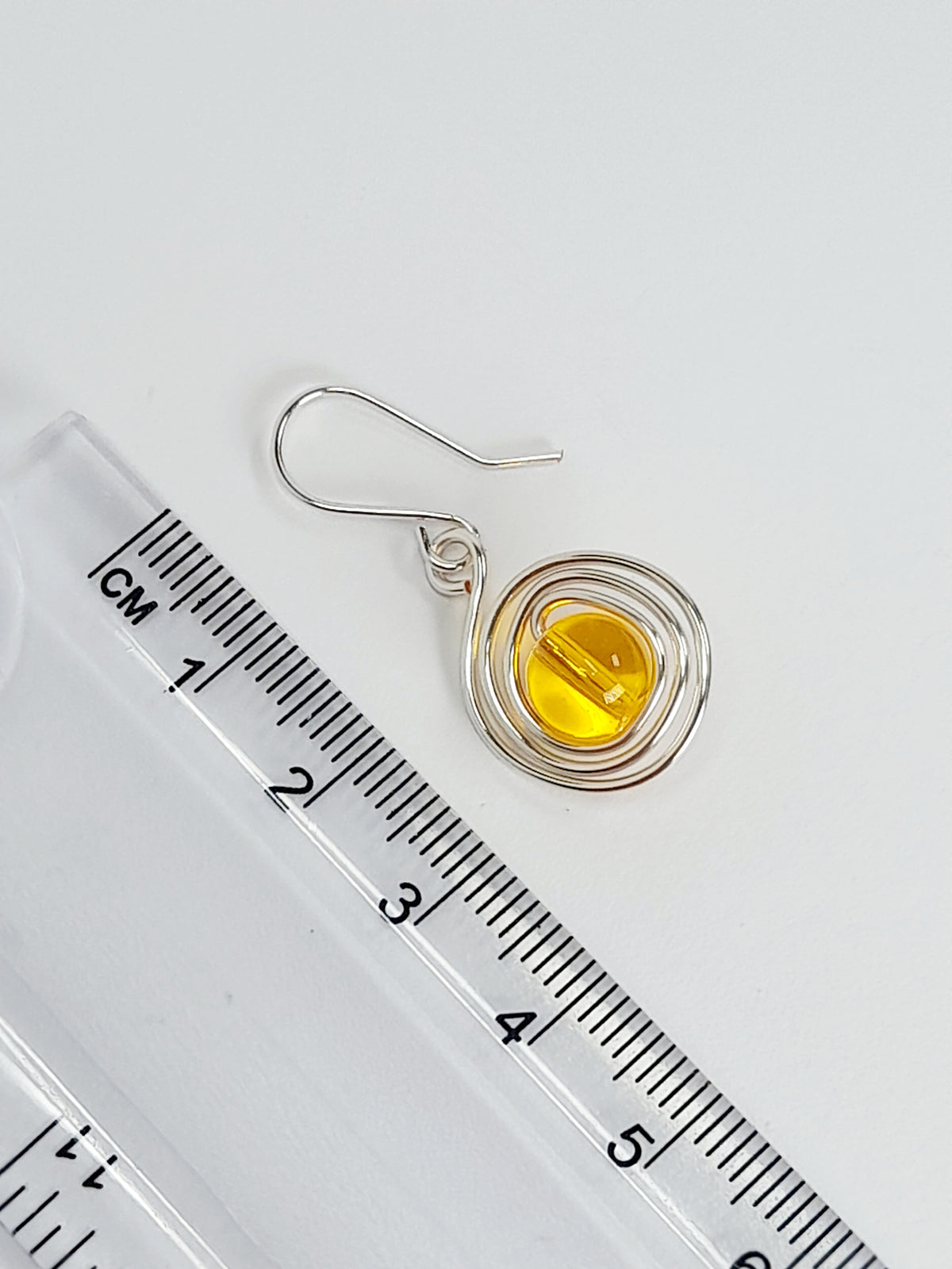 Handmade Silver Swirl Drop Earrings with Yellow Miracle Bead