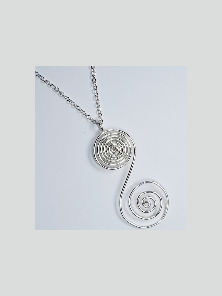 Large "S" shaped silver plated spiral pendant hanging on a silver plated chain.