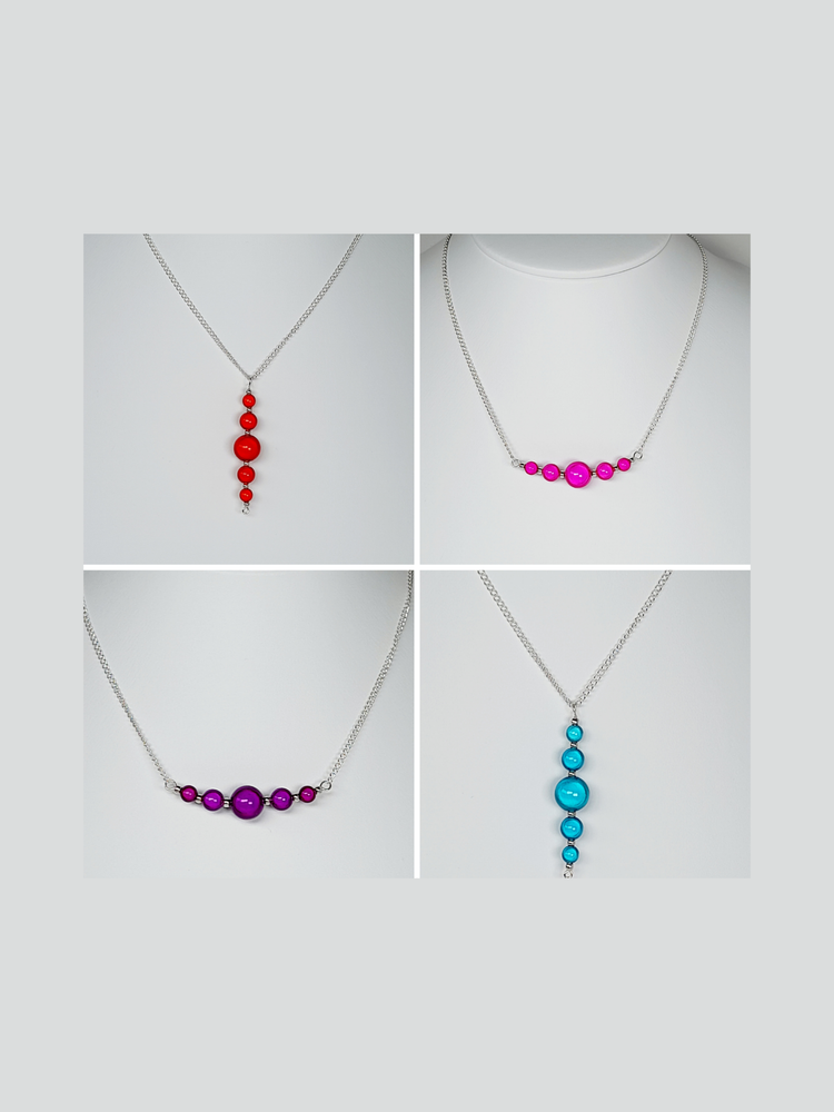 Collage of bright miracle bead necklaces with a graduated bar of beads, finished with silver plated chain and a silver plated lobster clasp.