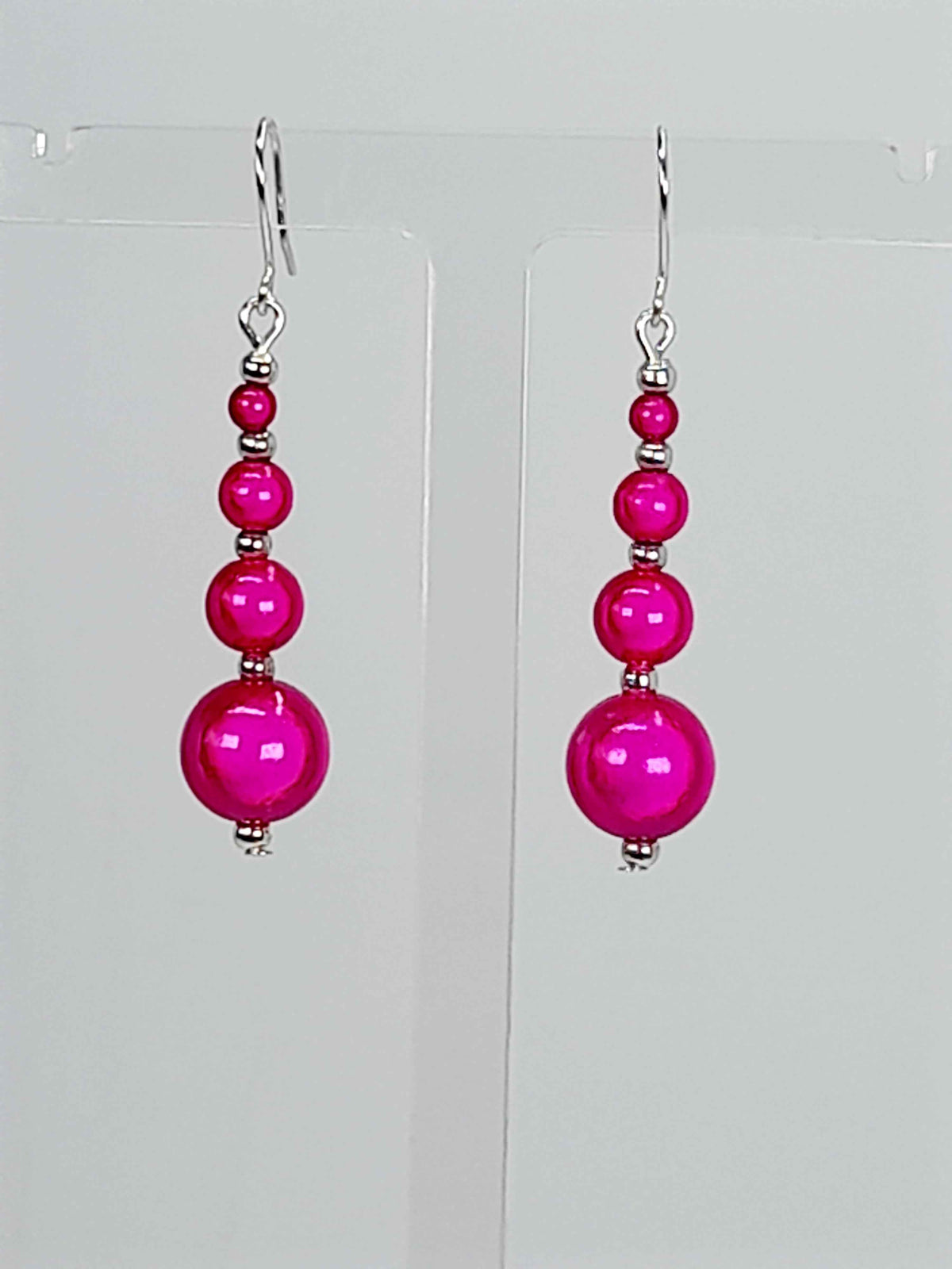 Hot pink miracle bead drop earrings with silver plated  earwires.