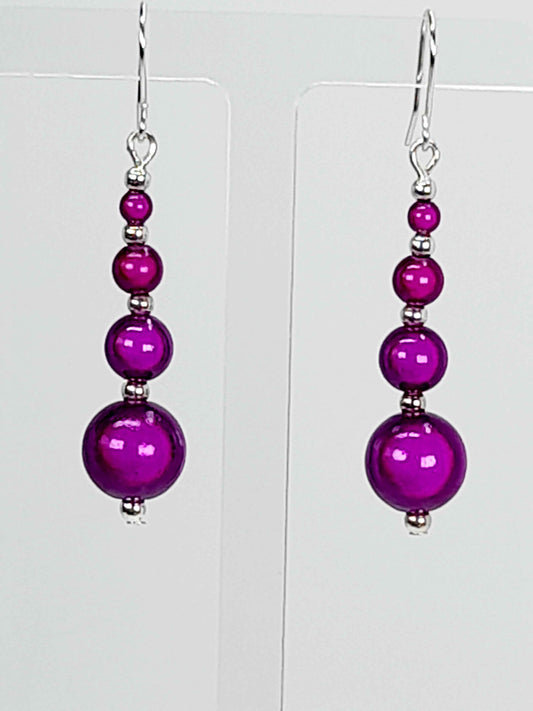 Bright purple miracle bead drop earrings with silver platec earwires.