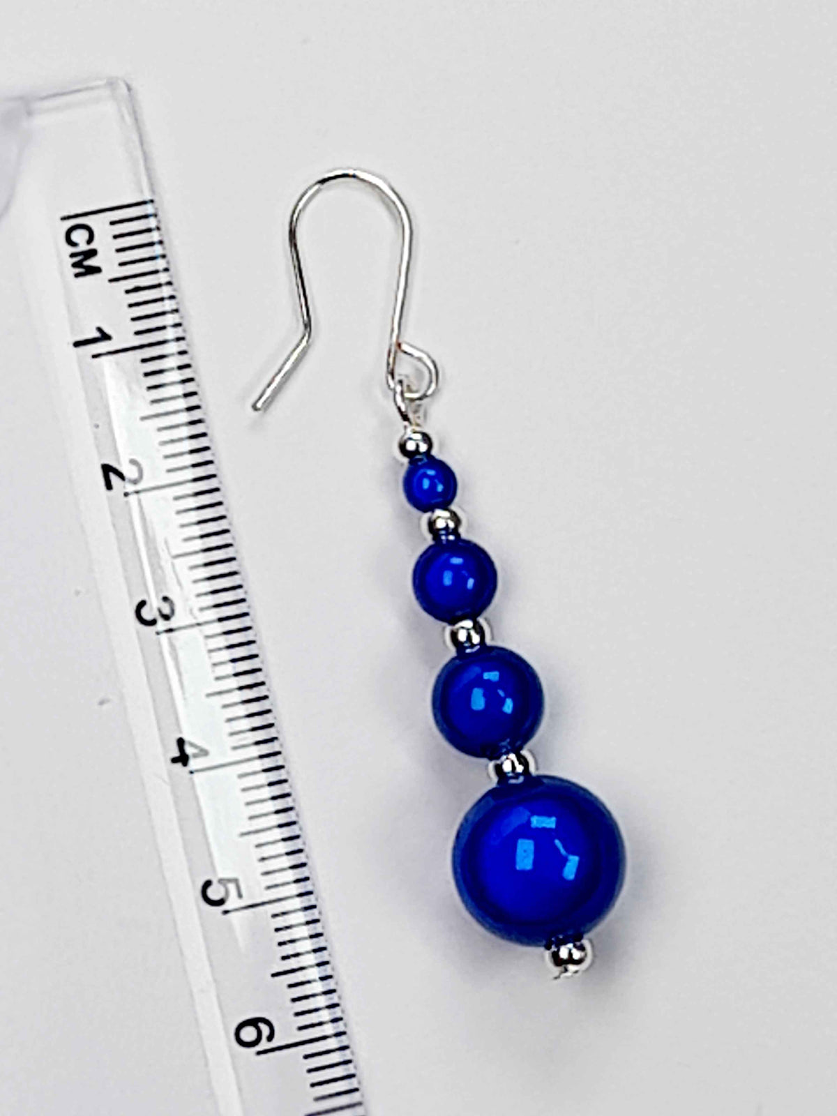 Bright Blue Miracle Bead Earrings  With A Ruler Showing 6cm Drop