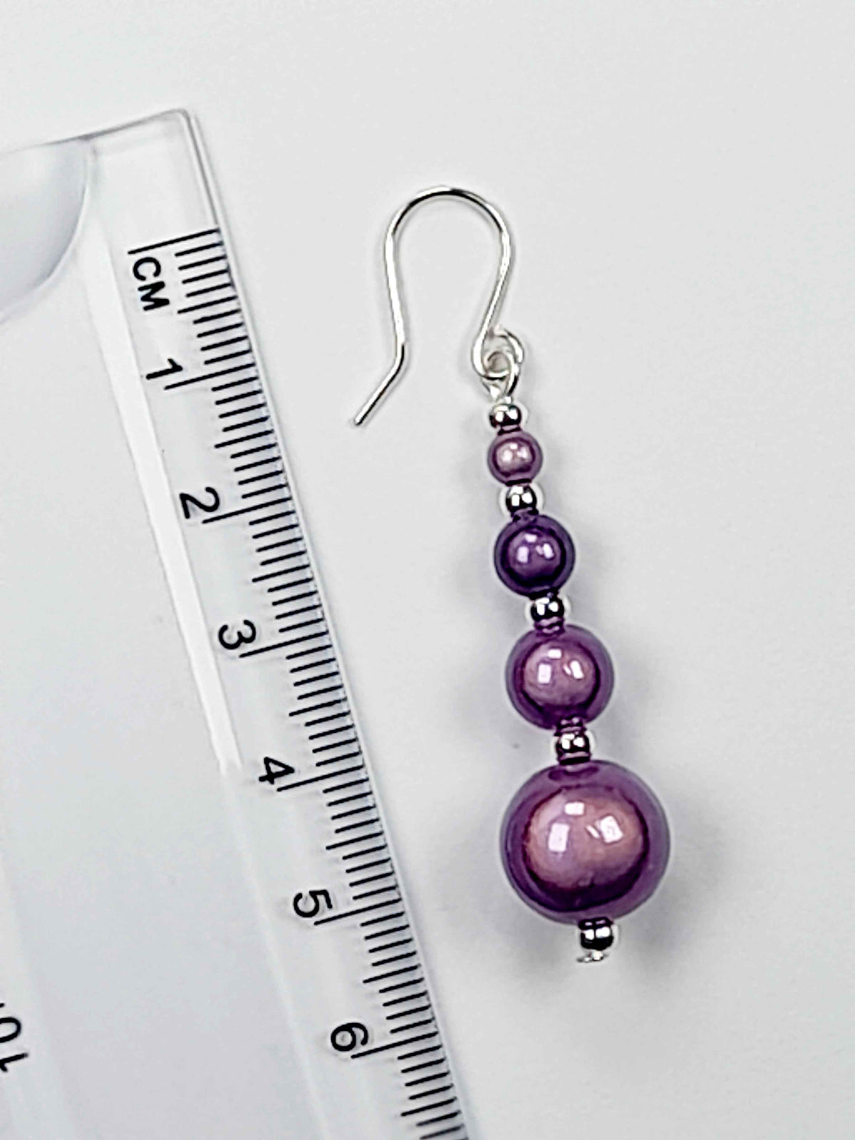 Lilac miracle bead earring displayed with a ruler showing 6cm drop