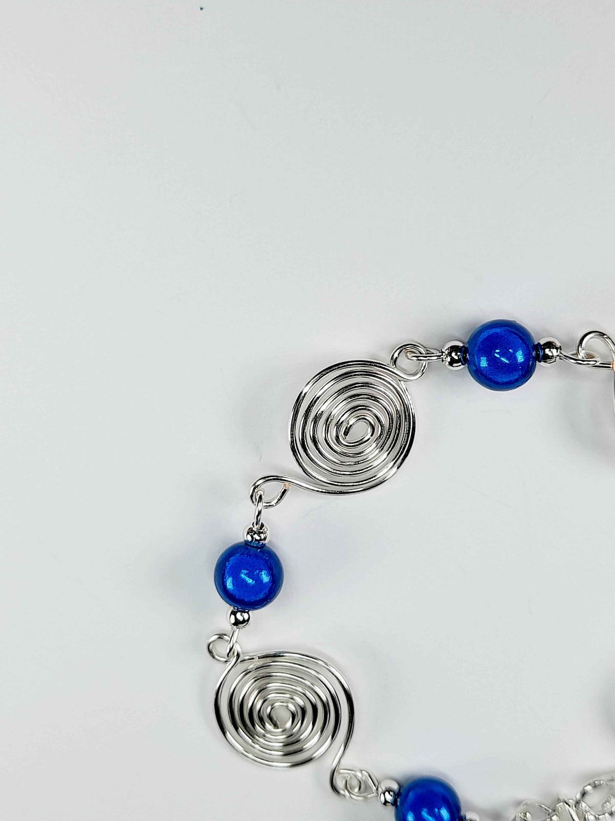 Dainty Silver Spiral & Blue Bead Bracelet – Handmade Adjustable Design