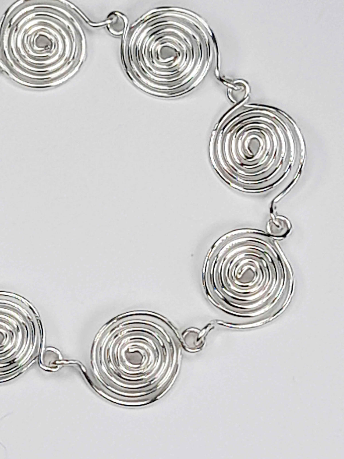 Silver spiral bracelet detail – close-up of handcrafted wire swirls