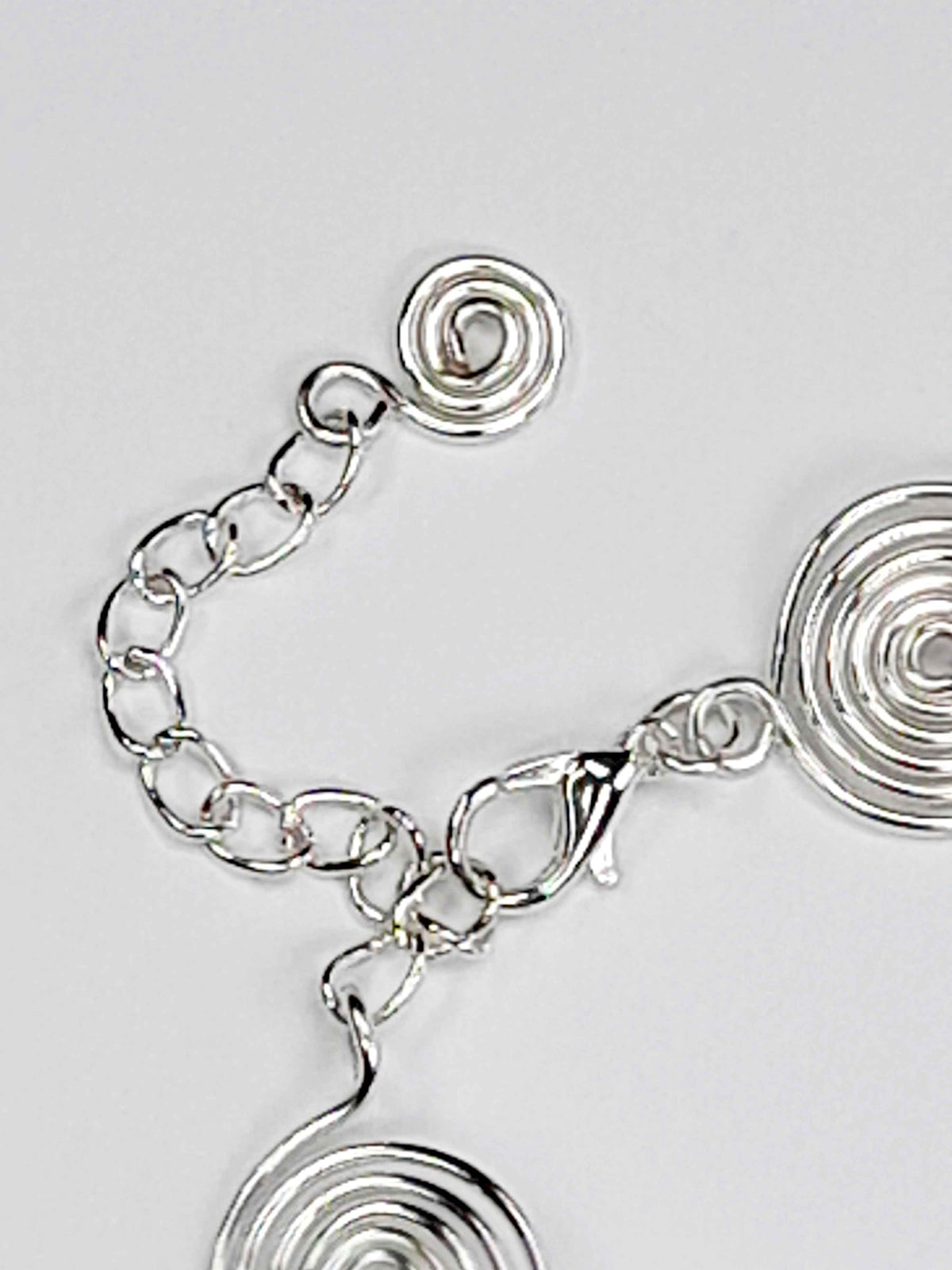 Silver spiral bracelet detail – close-up of handcrafted wire swirls