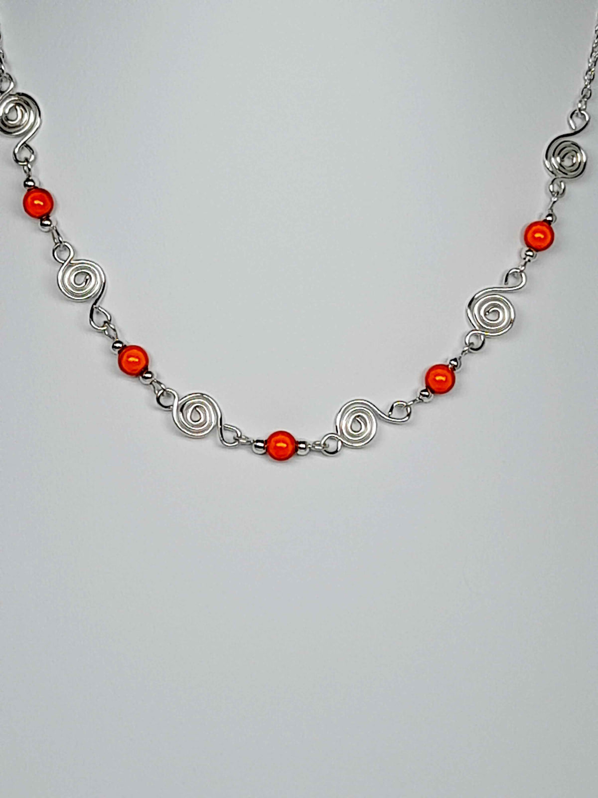 Dainty Silver Spiral Necklace with Orange Miracle Beads,  Handmade Lightweight Jewellery