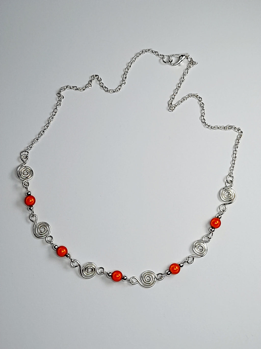 Dainty Silver Spiral Necklace with Orange Miracle Beads,  Handmade Lightweight Jewellery