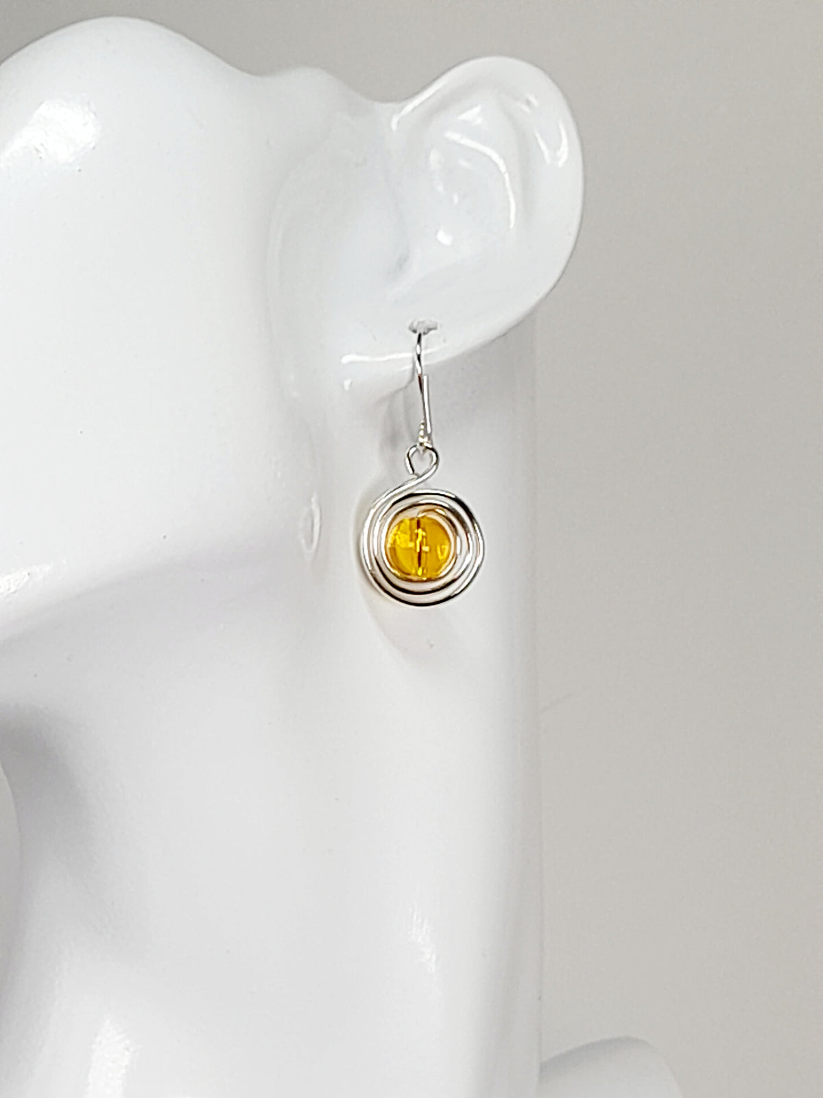 Handmade Silver Swirl Drop Earrings with Yellow Miracle Bead