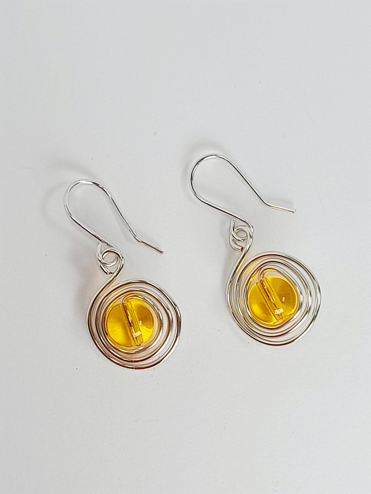 Handmade Silver Swirl Drop Earrings with Yellow Miracle Bead