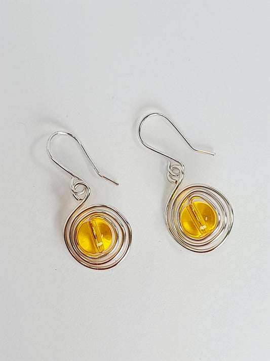 Handmade Silver Swirl Drop Earrings with Yellow Miracle Bead